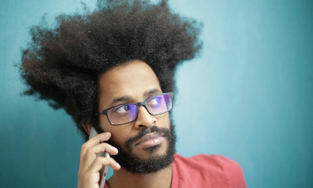 man in red crew neck shirt wearing black framed eyeglasses